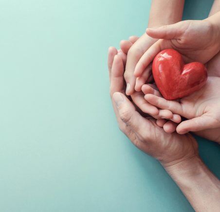 adult-and-child-hands-holding-red-heart-on-aqua-background-heart-health-donation-CSR-concept-world-heart-day-world-health-day-family-day-1169662101_2125x1416-452x436